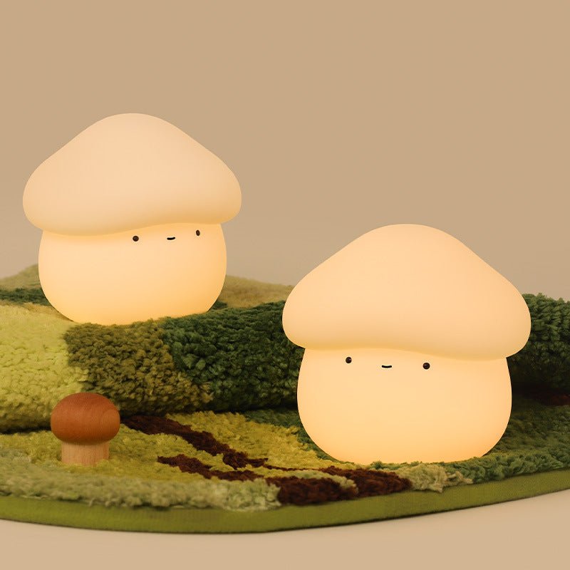 Two mushroom-shaped lamps on a green fabric background