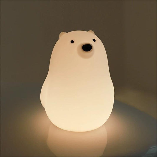 A silicone bear-shaped pat control lamp emitting a soft glow, with a simple and cute design.